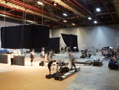 Busy film studio with large hanging drapes